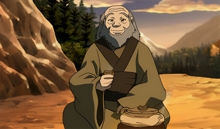 Uncle Iroh from Avatar The Last Airbender calmly drinking tea outdoors with mountains and forest in the background.