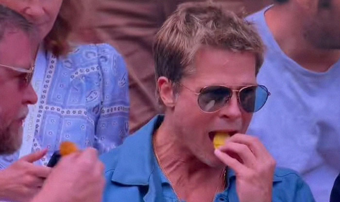 Brad Pitt enjoying a snack at Wimbledon, surprising fans with his age and youthful appearance.