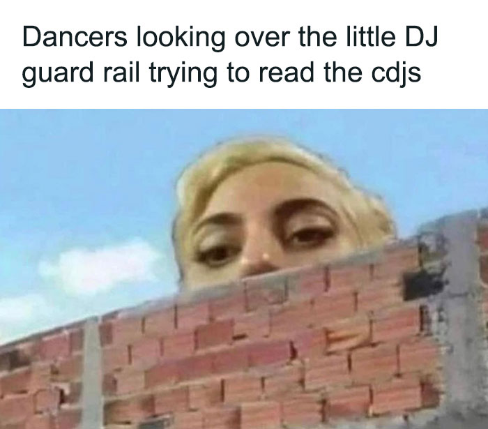 "Person peeking over a brick wall, capturing a humorous dance meme moment at a DJ event."
