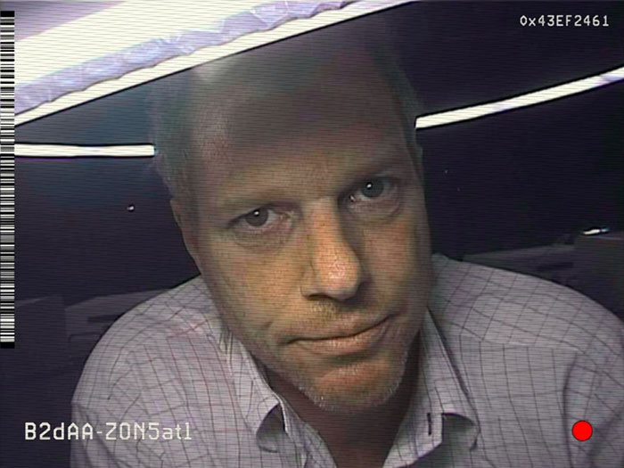 Edwin Jenner looking to camera lens 