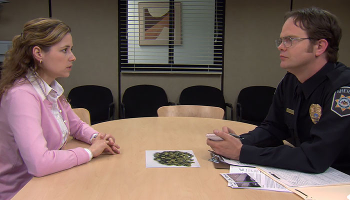 Pam Halpert talking to Dwight Schrute while he is in a sheriffs uniform
