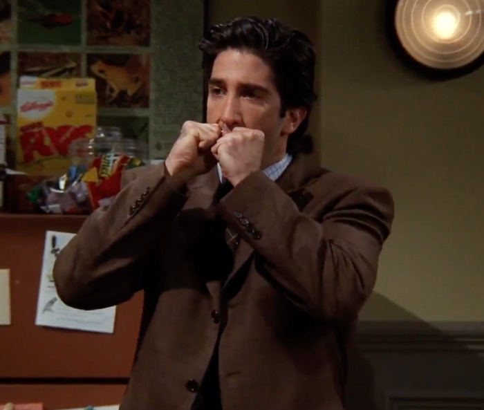 Ross wearing brown suite looking angry 