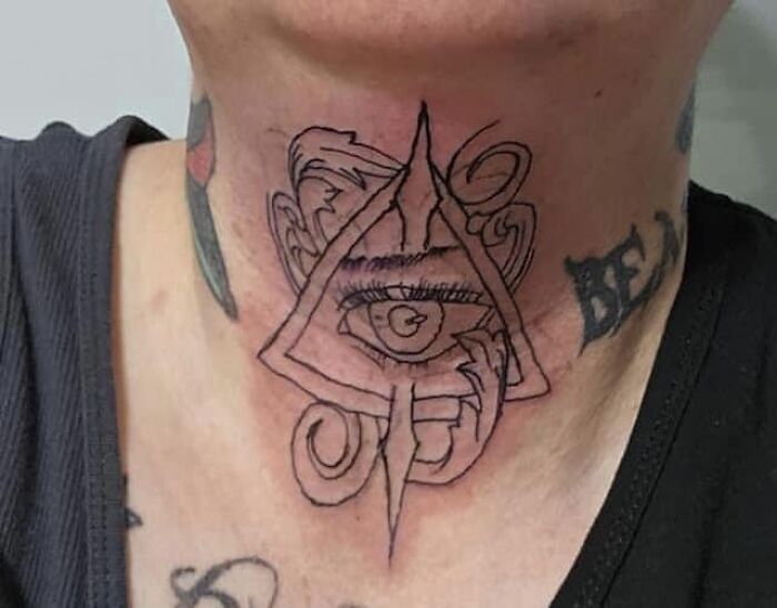 Neck tattoo of an eye within a triangle surrounded by abstract lines; an example of worst tattoos shared online.