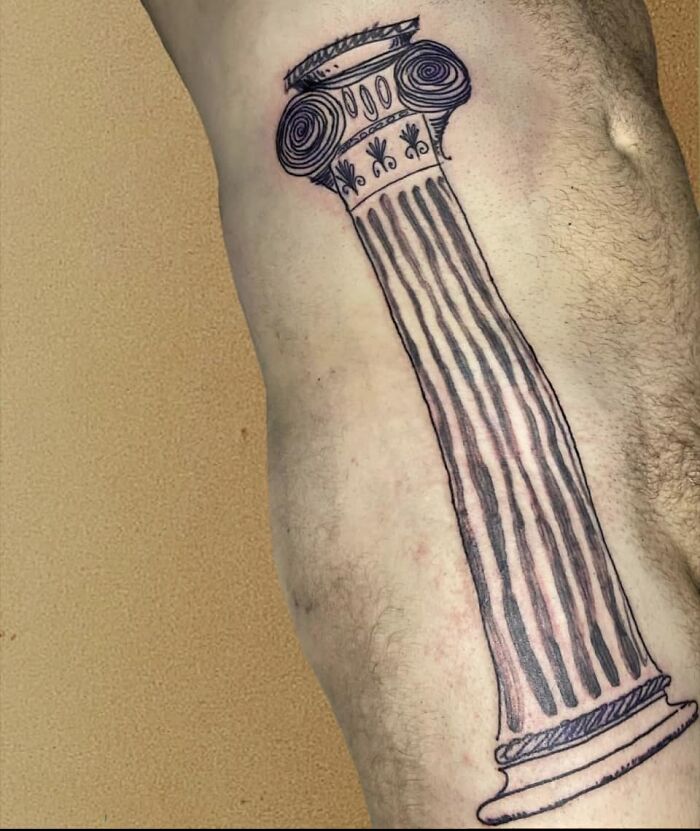 Unique tattoo of an Ionic column on a person's leg, showcasing one of the worst tattoos shared for humor.