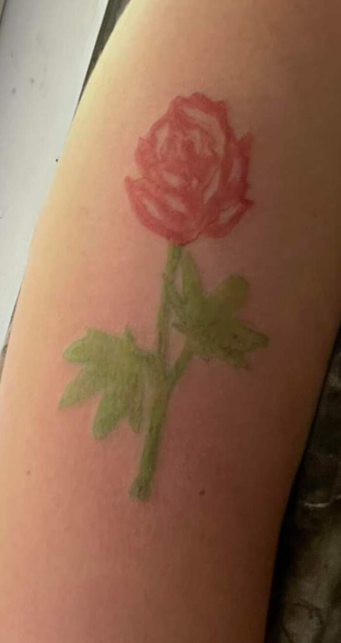 Amateurish rose tattoo on arm, categorized among the worst tattoos shared for humor.