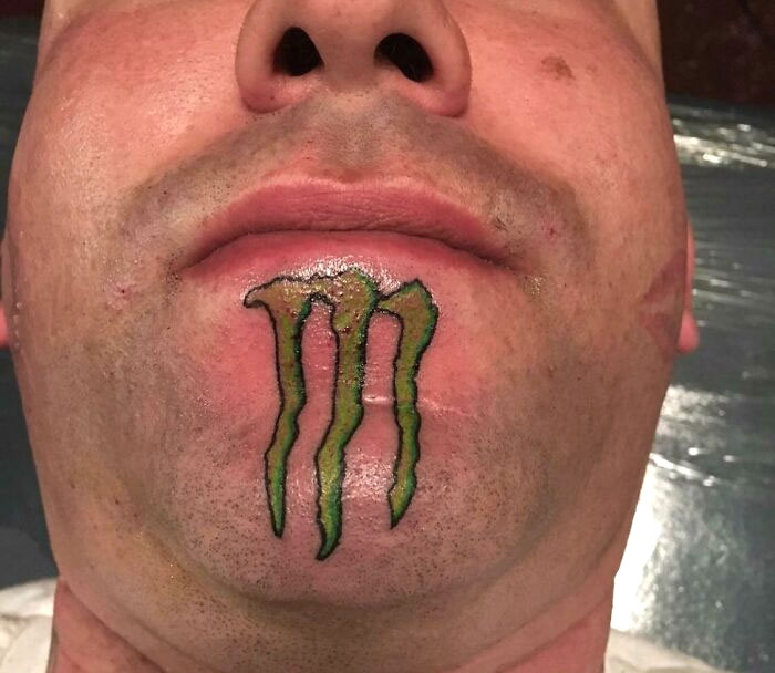 Chin tattoo of a green claw mark, showcasing a permanent mistake in getting inked.