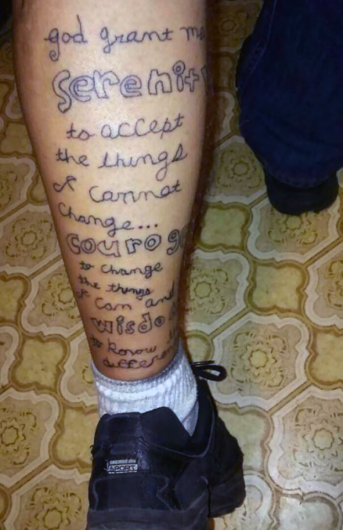 Tattoo with the Serenity Prayer on a leg, demonstrating a common inked mistake.