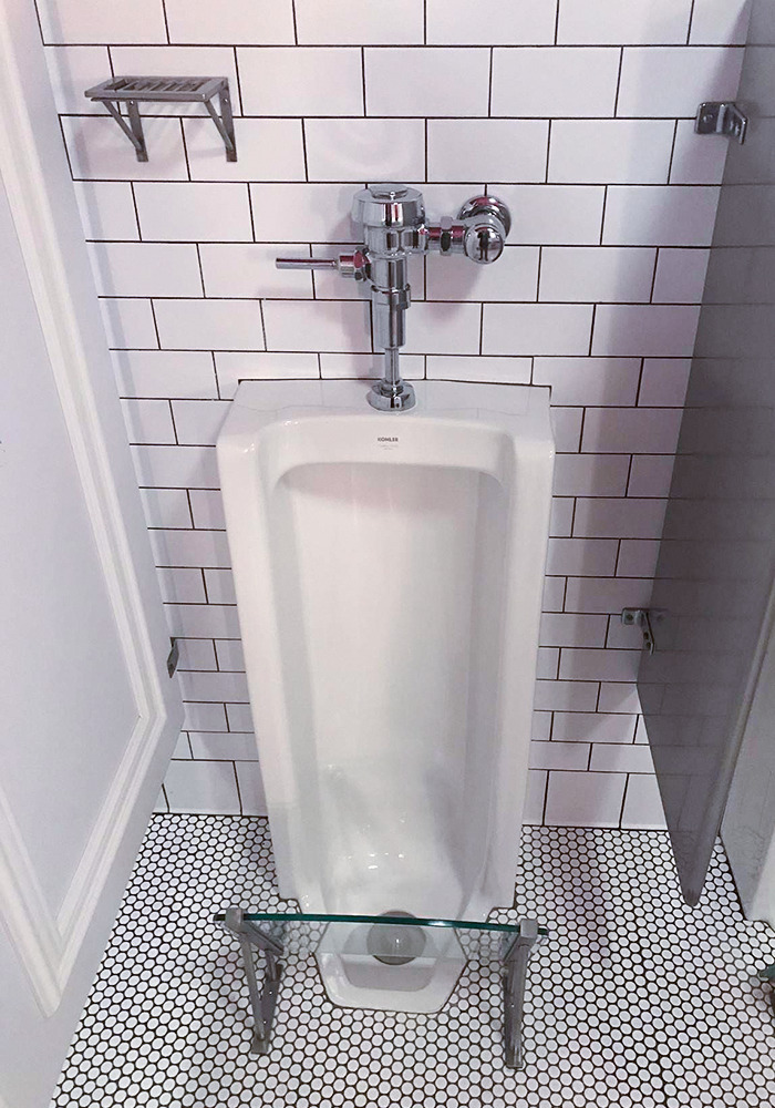 There's A Restroom At A Bar In Minneapolis That Features A Splash Guard For Your Shoes And A Mini Shelf For Your Drink