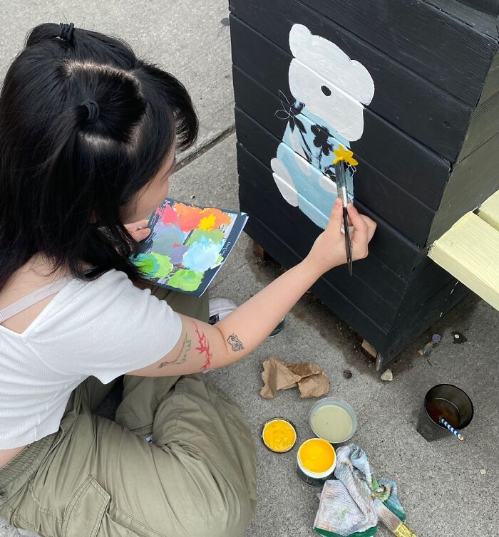 Artist Decorating Flower Box. Toronto Canada