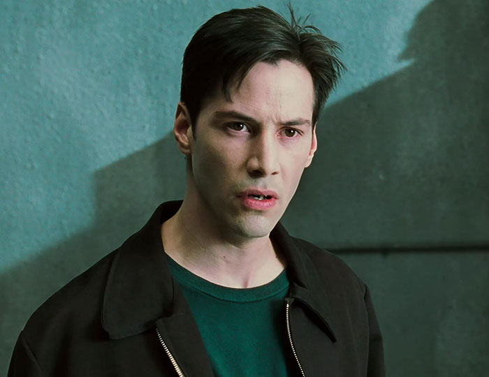 Keanu Reeves wearing brown jacket