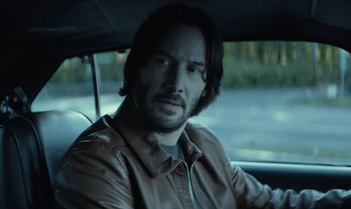 Keanu Reeves wearing brown jacket