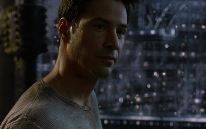 Keanu Reeves wearing gray shirt