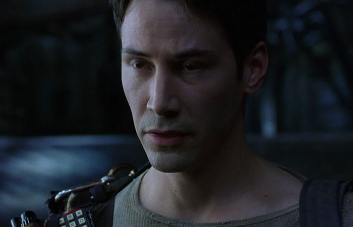 Keanu Reeves wearing green shirt