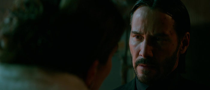 Keanu Reeves wearing black suit