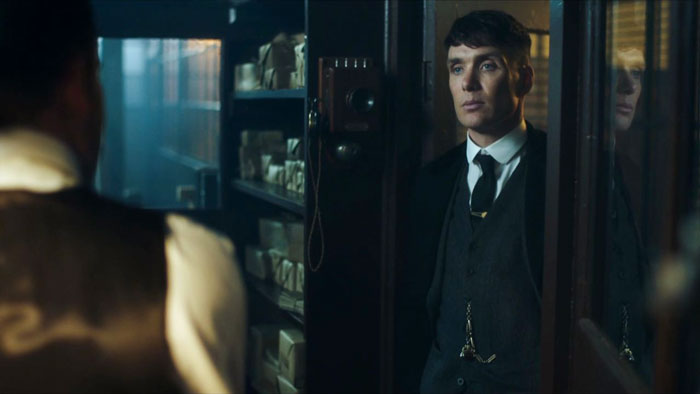 Tommy Shelby standing between the doors