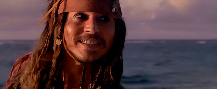 Jack Sparrow smiling with ocean background, capturing the adventurous spirit of Pirates of the Caribbean quotes and treasure.