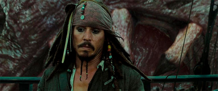 Jack Sparrow on a ship deck with beads and bandana, representing iconic Pirates of the Caribbean quotes and character.