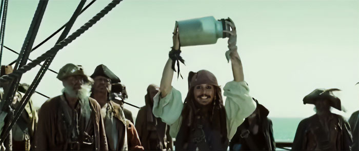 Jack Sparrow holding a jar triumphantly on a ship deck surrounded by crew, capturing Pirates of the Caribbean quotes theme.