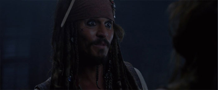 Jack Sparrow looking surprised at night, a memorable moment from Pirates of the Caribbean quotes and scenes.
