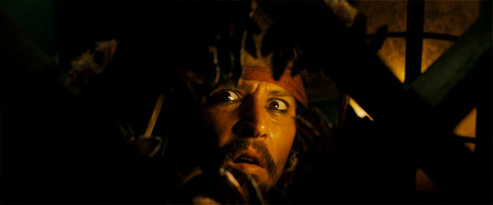 Jack Sparrow with a troubled expression, highlighting memorable Pirates of the Caribbean quotes in a dark setting.
