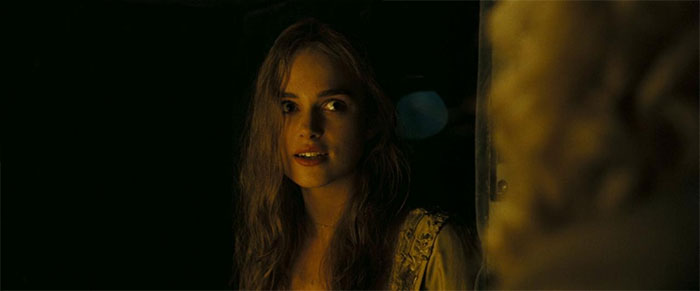 Elizabeth Swann from Pirates of the Caribbean featured in a dark scene, highlighting memorable Pirates of the Caribbean quotes.