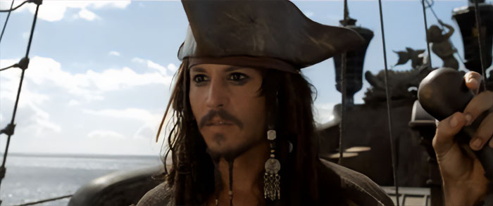 Jack Sparrow on pirate ship looking into the distance with ocean background capturing Pirates of the Caribbean quotes vibe.