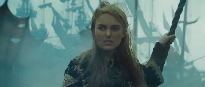 Elizabeth Swann gripping a rope on a ship with misty sails in the background from Pirates of the Caribbean quotes scene.