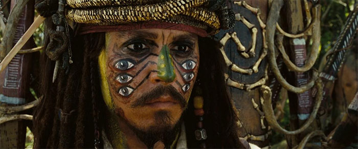 Jack Sparrow with elaborate face paint and pirate attire, a key figure in Pirates of the Caribbean quotes treasure collection