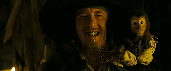 Captain Barbossa smiling with money on his shoulder, capturing the spirit of Pirates of the Caribbean quotes and treasure.