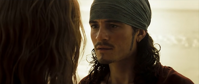 Will Turner speaking seriously to a woman, capturing a moment from Pirates of the Caribbean quotes about loyalty and honor.