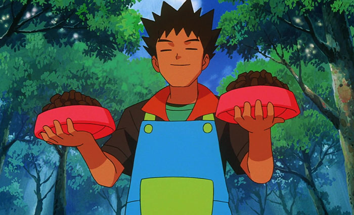 Brock Harrison standing in the forest and holding two red bowls with food - 49