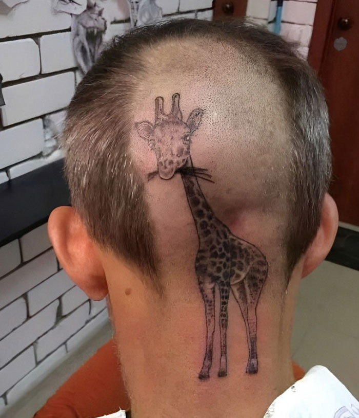 Giraffe tattoo on the back of a person's shaved head, showcasing unusual tattoo choices.