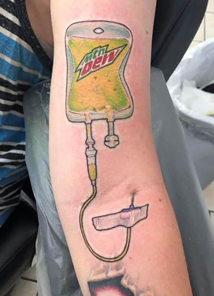 Arm tattoo resembling a Mountain Dew IV bag, showcasing a tattoo that might not have been well thought through.