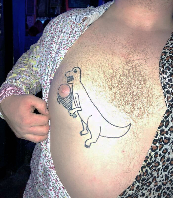 Tattoo of a dinosaur holding an ice cream cone on a man's chest with floral and leopard print shirts.