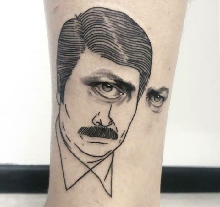 Unusual tattoo design on leg featuring two overlapping faces, illustrating a creative yet questionable tattoo choice.