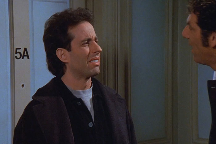 Jerry wearing brown jacket and gray shirt, delivering one of the funniest Seinfeld quotes about everyday life.