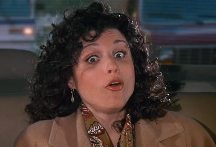 Elaine from Seinfeld wearing a brown jacket and colorful scarf, capturing the funniest Seinfeld quotes vibe.