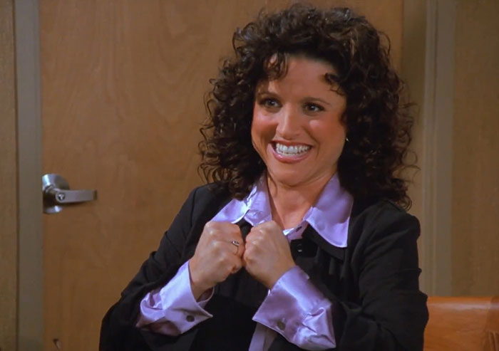 Elaine from Seinfeld wearing a black jacket and purple shirt, showcasing one of the funniest Seinfeld quotes moments