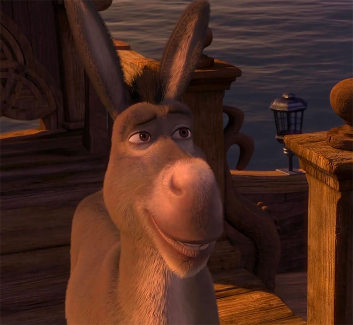 Donkey smiling on a wooden boat at sunset, a memorable character from Shrek quotes in the deep swamp series.