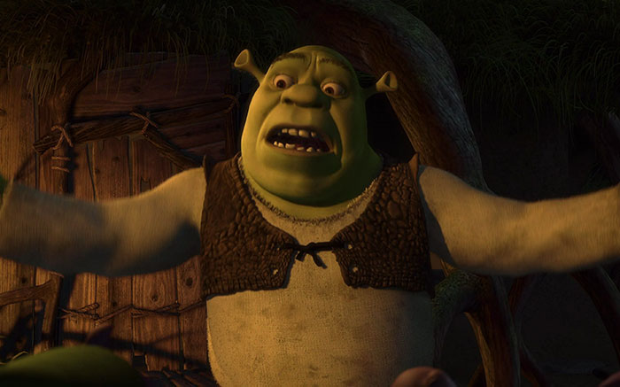 Shrek speaking passionately with others in the deep swamp, featuring memorable Shrek quotes from the series.