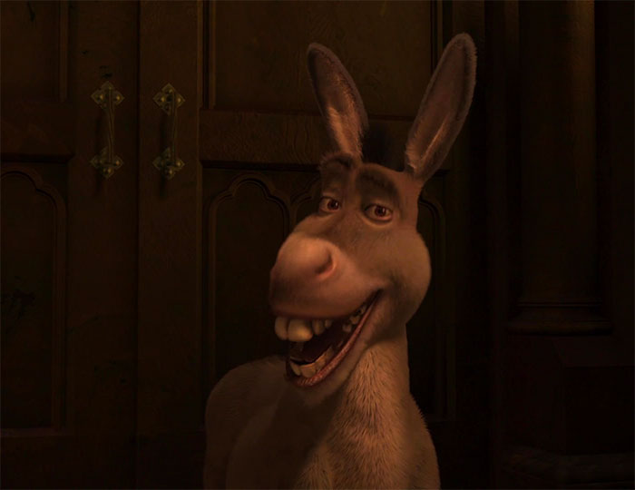 Donkey smiling with wide grin in a dimly lit room, capturing the fun spirit of Shrek quotes from the deep swamp.