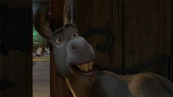 Donkey smiling inside a wooden doorway, a joyful character from popular Shrek quotes about the deep swamp.