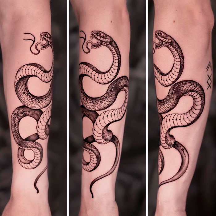 Snake tattoo design wrapped around a forearm, showcasing intricate details and scales in black ink.