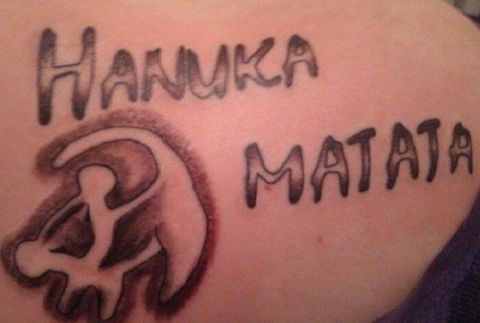 Misspelled tattoo with "Hanuka Matata" and a poorly drawn design, depicting a tattoo fail.