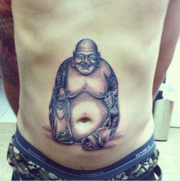 Buddha tattoo with belly button as a funny navel feature, representing a tattoo fail.
