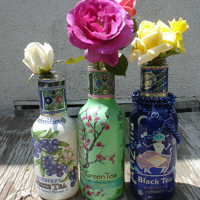 Three decorative tea bottles repurposed as vases holding colorful roses, illustrating things that disappeared unnoticed.