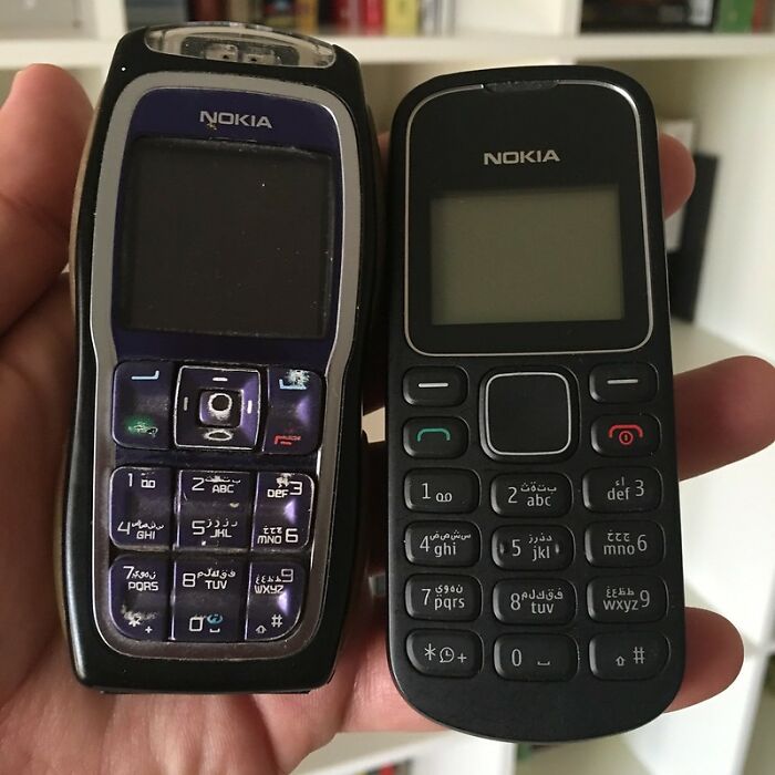 Two vintage Nokia mobile phones held in a hand, symbolizing technology that eventually disappeared unnoticed.