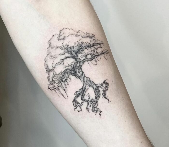 Tree tattoo design on forearm, showcasing detailed branches and roots, celebrating the wonders of nature.