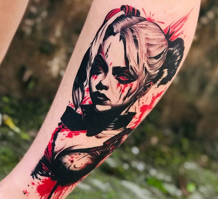 Trash Polka tattoo featuring an intricate portrait with bold black and red elements.