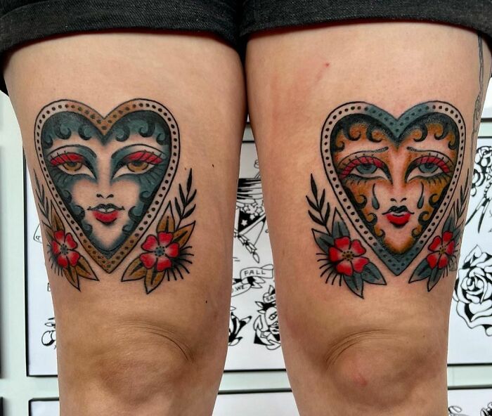 Heart-shaped American traditional tattoos with floral accents on legs.